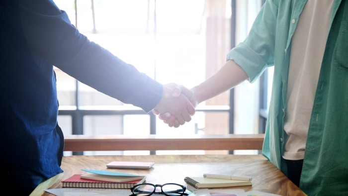 two persons shaking hands