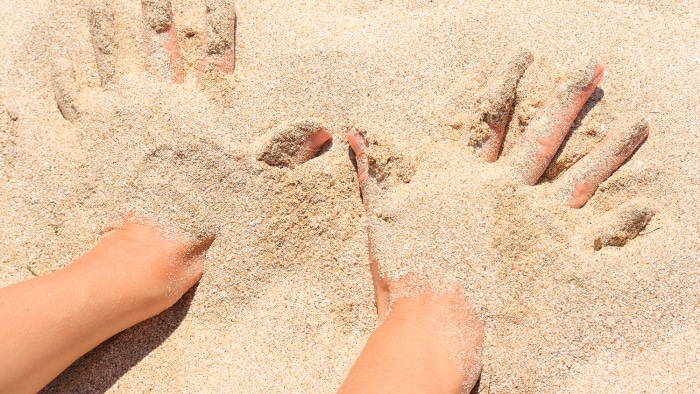 hands in the sand